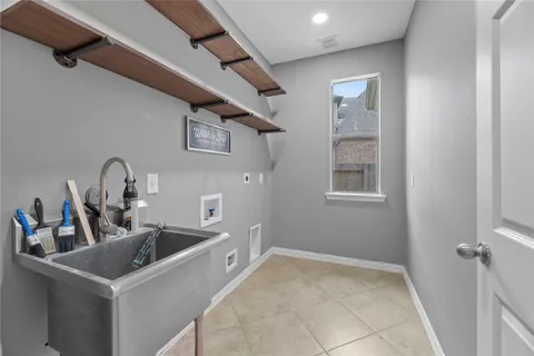 a kitchen with sink and refrigerator