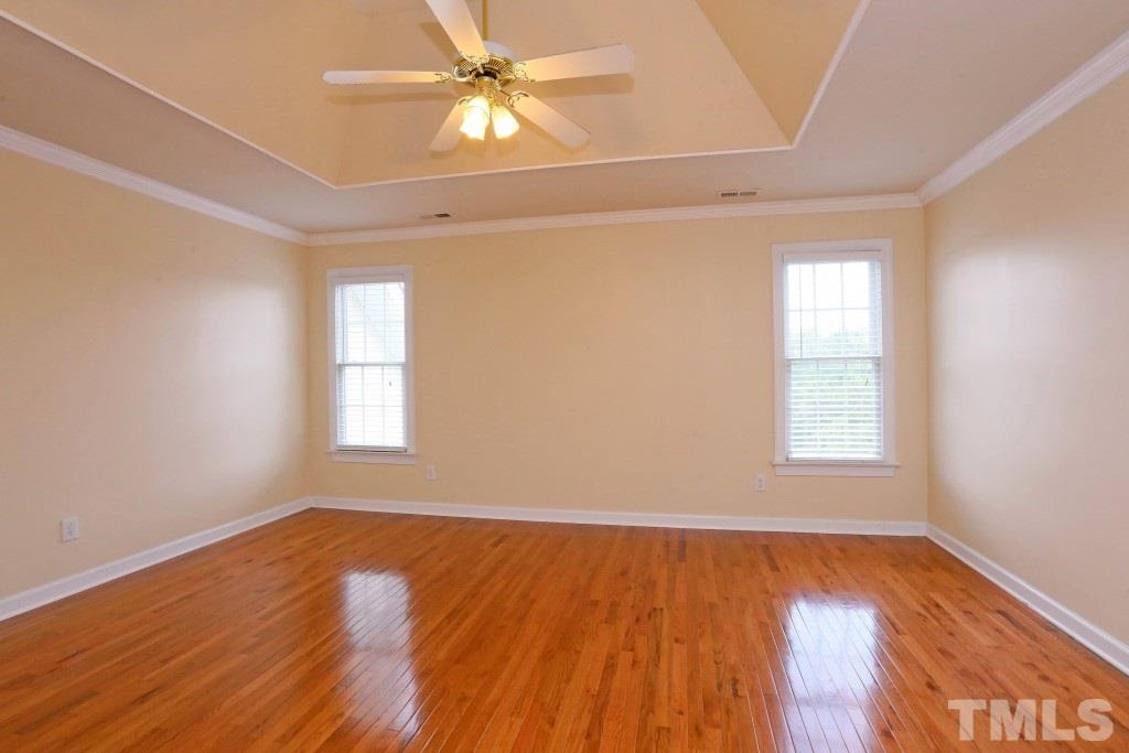 8204 Eden Close Court Raleigh, NC 27613 - Photo 14 of 25 wooden floor in an empty room with a window