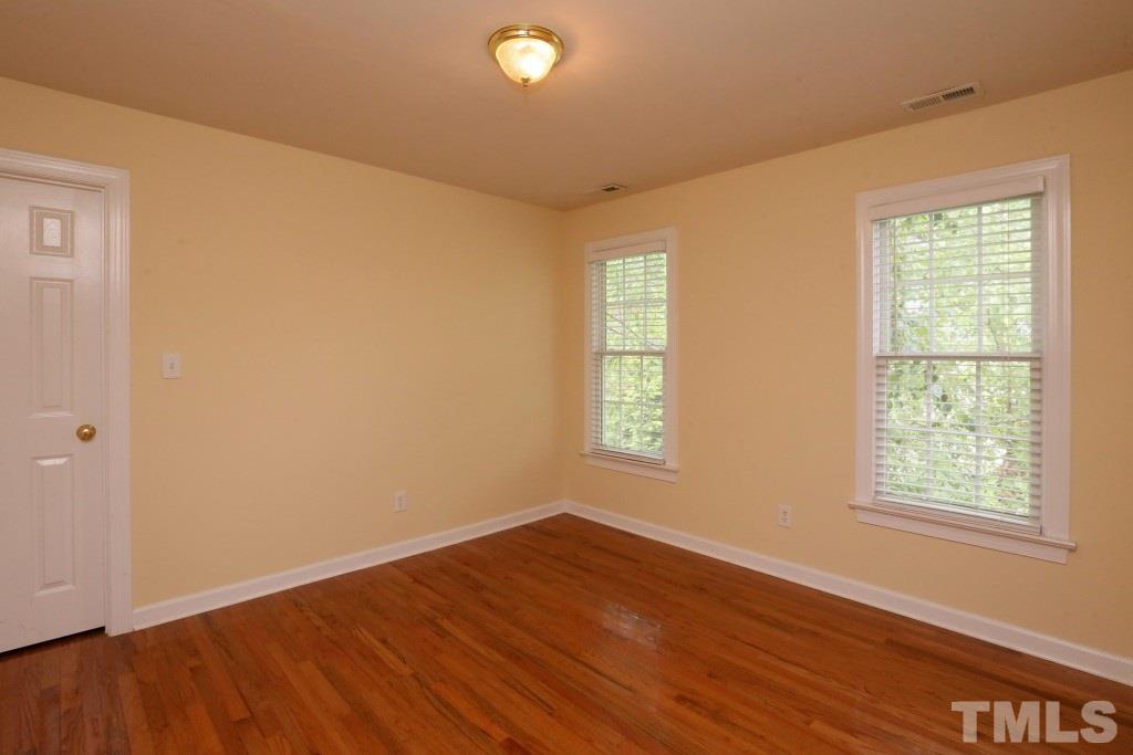 8204 Eden Close Court Raleigh, NC 27613 - Photo 20 of 25 a view of an empty room with wooden floor and a window