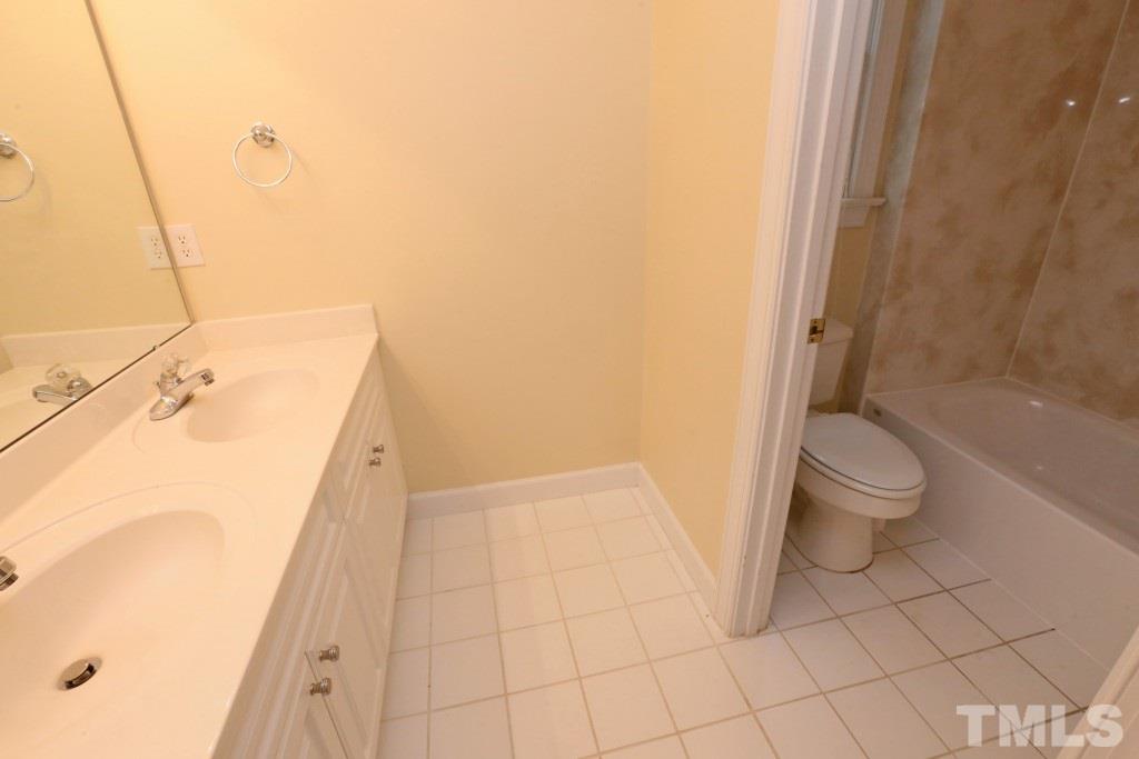 8204 Eden Close Court Raleigh, NC 27613 - Photo 21 of 25 a bathroom with a bathtub and toilet