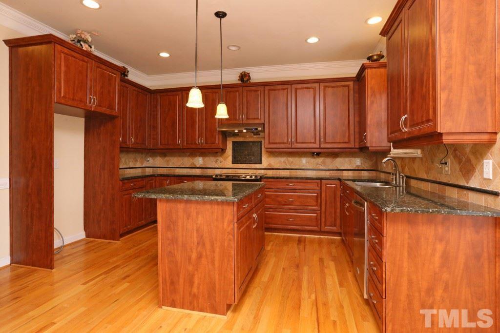 8204 Eden Close Court Raleigh, NC 27613 - Photo 6 of 25 a kitchen with stainless steel appliances granite countertop a sink refrigerator and cabinets