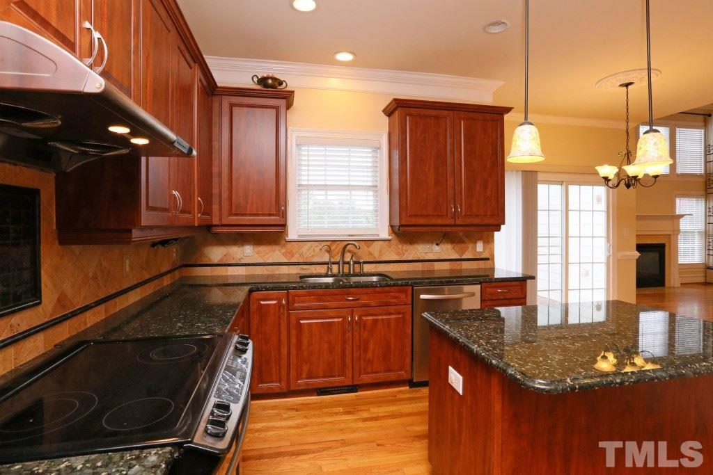 8204 Eden Close Court Raleigh, NC 27613 - Photo 7 of 25 a kitchen with stainless steel appliances granite countertop a stove a sink and a microwave