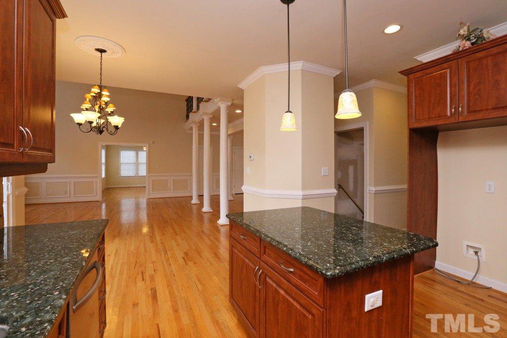 8204 Eden Close Court Raleigh, NC 27613 - Photo 8 of 25 a kitchen with stainless steel appliances granite countertop a kitchen island a stove and a wooden floors