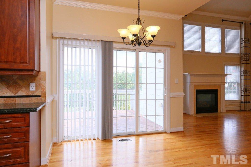 8204 Eden Close Court Raleigh, NC 27613 - Photo 9 of 25 a view of an empty room with wooden floor and a window