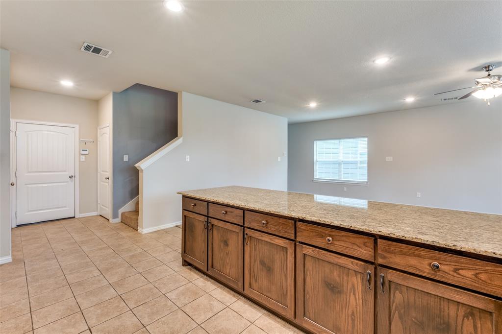 4662 Ralph Lane Dallas, TX 75227 - Photo 10 of 25 Spacious interior with tile flooring, wood-finish cabinetry, light-toned countertops, and recessed lighting