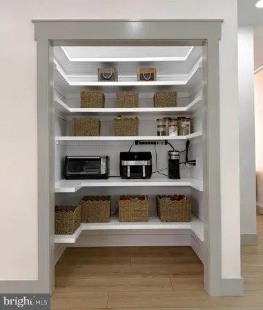 a kitchen with granite countertop white cabinets and stainless steel appliances