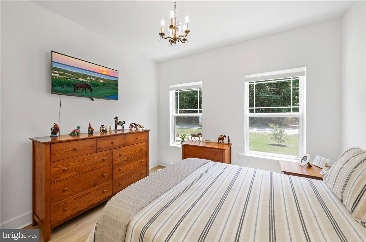 36755 Double Bridges Road Frankford, DE 19945 - Photo 20 of 38 a bedroom with a bed and a flat tv screen on dresser
