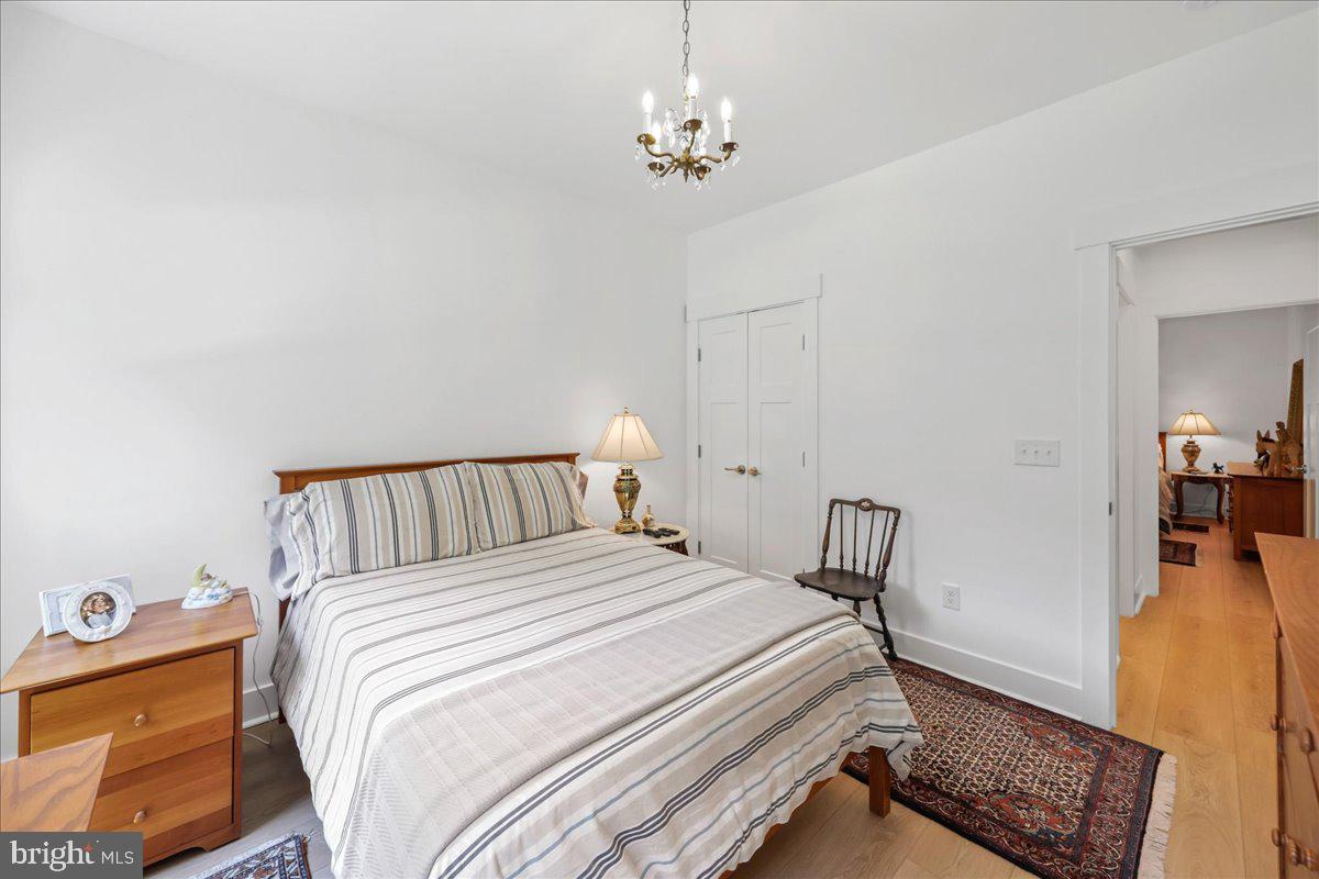 36755 Double Bridges Road Frankford, DE 19945 - Photo 22 of 38 a bedroom with a bed and a chandelier