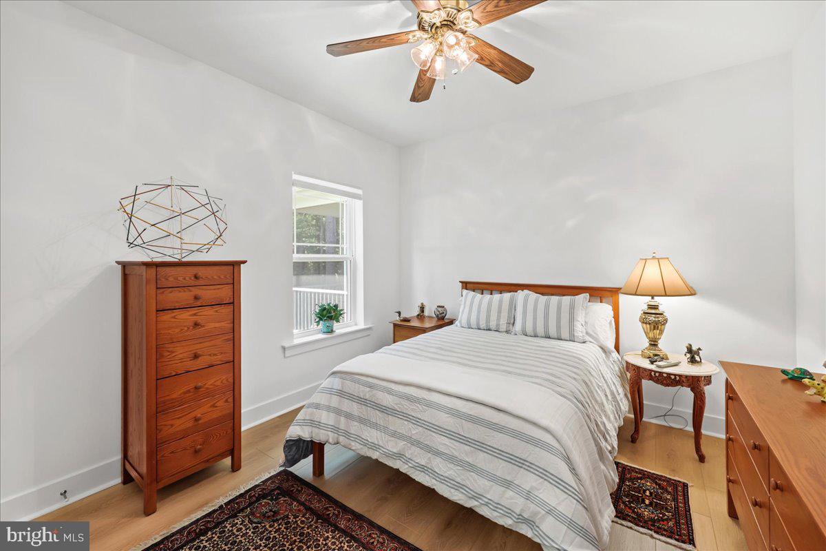 36755 Double Bridges Road Frankford, DE 19945 - Photo 23 of 38 a bedroom with a bed and wooden floor