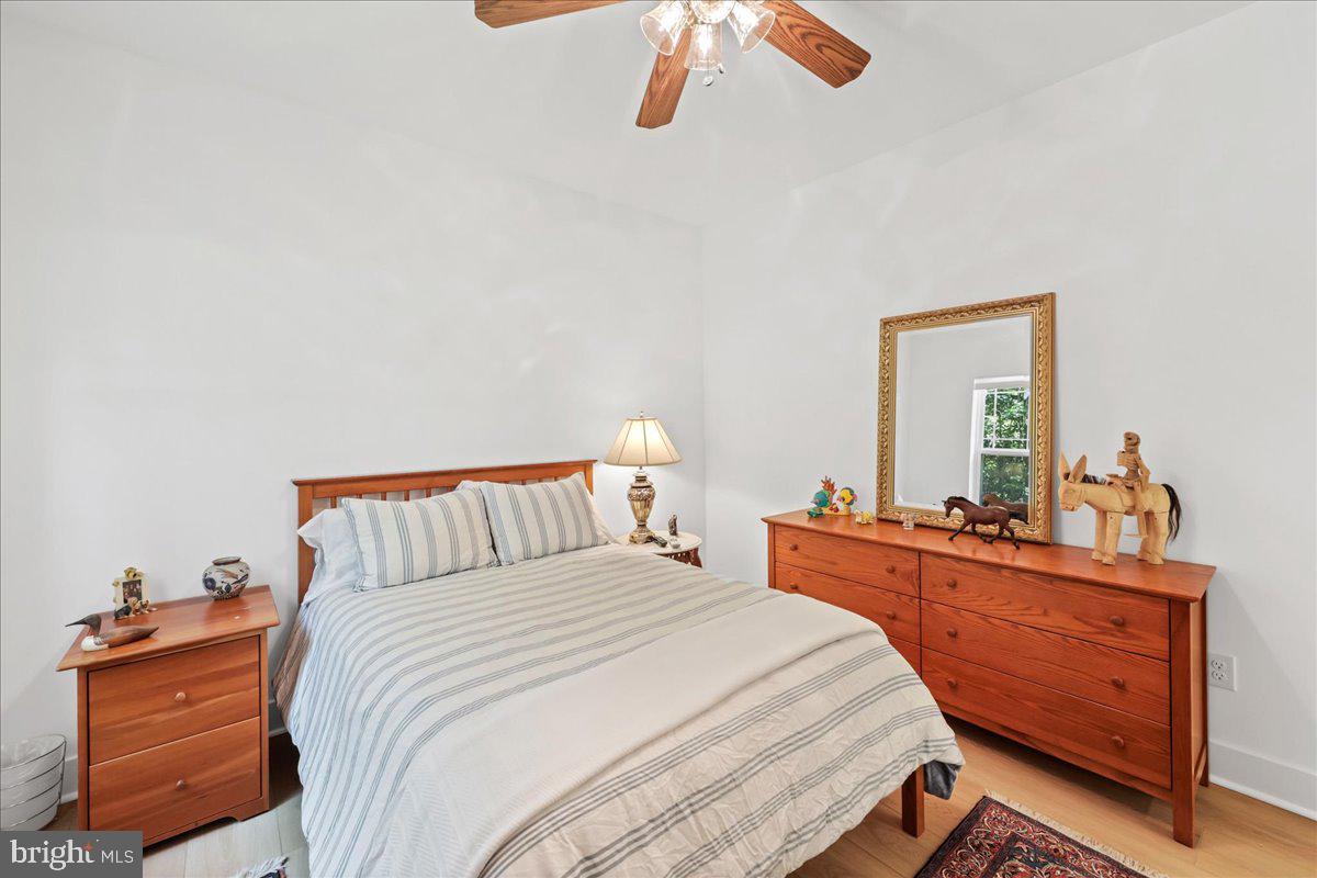 36755 Double Bridges Road Frankford, DE 19945 - Photo 24 of 38 a bedroom with a bed and wooden floor