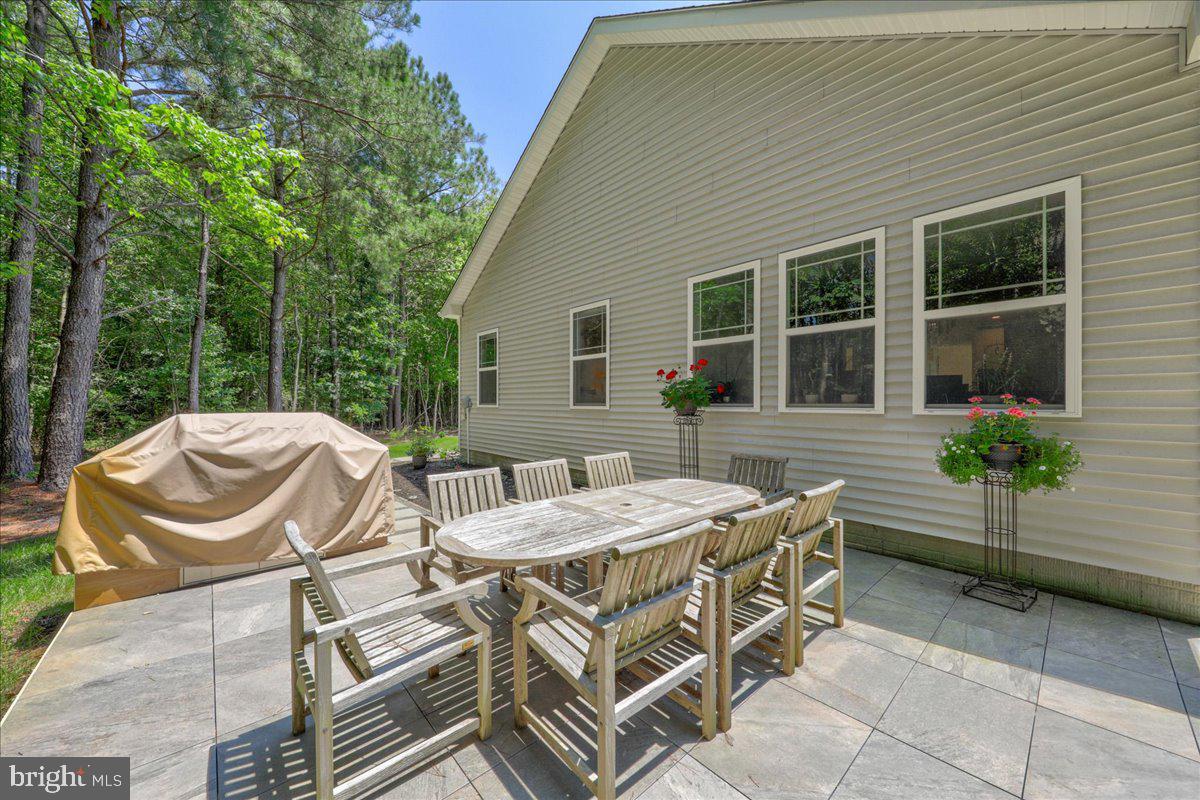 36755 Double Bridges Road Frankford, DE 19945 - Photo 38 of 38 a view of a dinning table and chairs in the patio