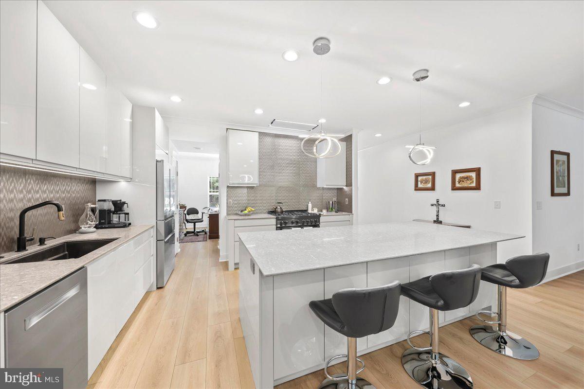 36755 Double Bridges Road Frankford, DE 19945 - Photo 7 of 38 a large kitchen with kitchen island a sink table and chairs