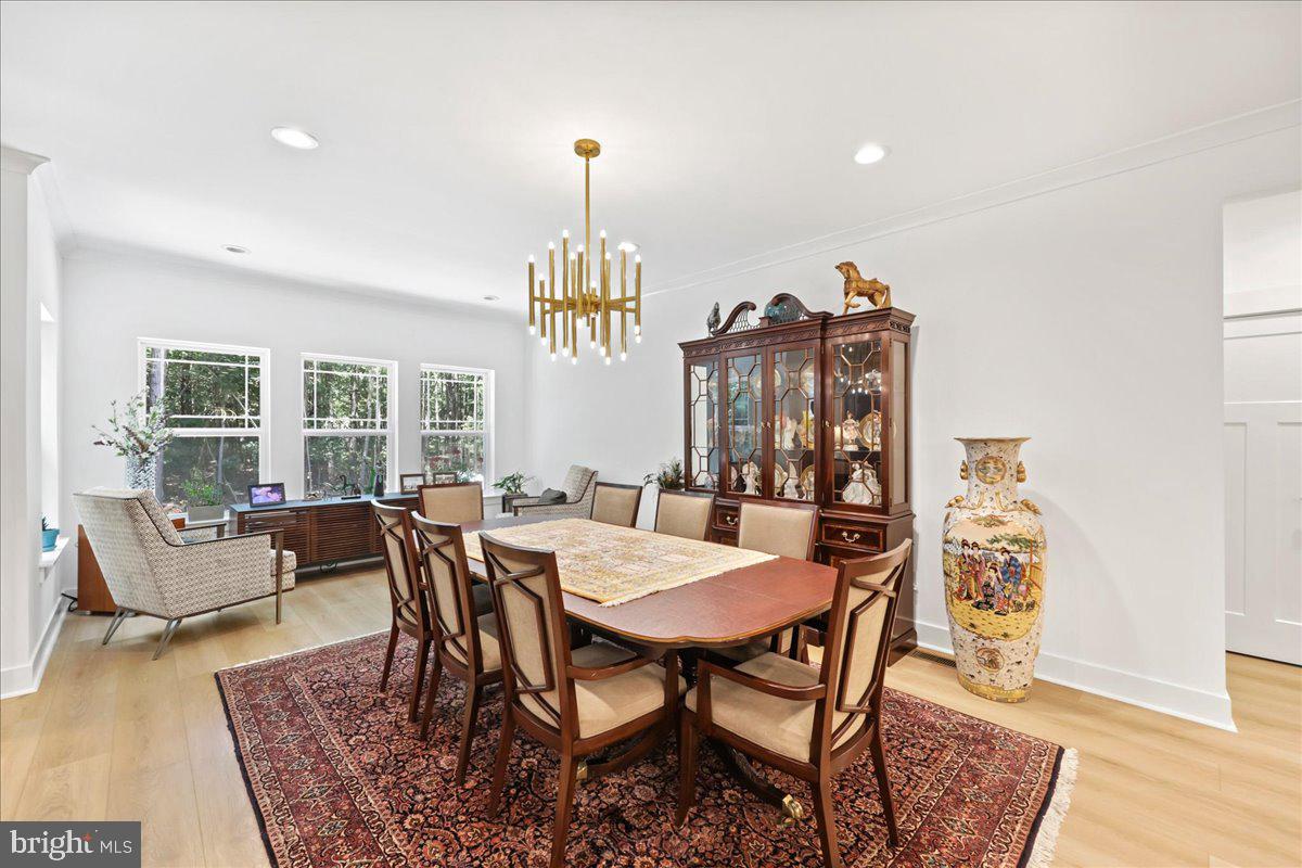 36755 Double Bridges Road Frankford, DE 19945 - Photo 10 of 38 a view of a dining room with furniture window and wooden floor