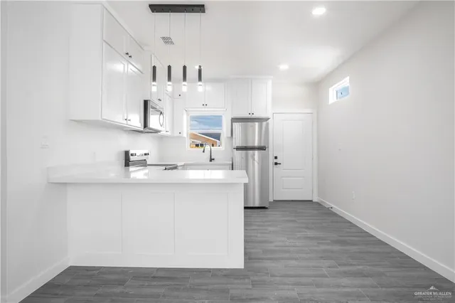a view of kitchen with wooden floor