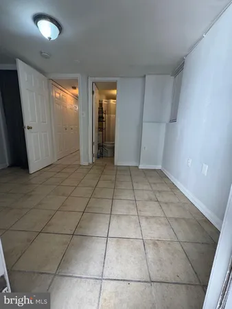a view of a livingroom with an empty space and a window