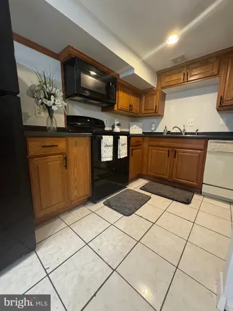 a kitchen with stainless steel appliances kitchen island granite countertop a sink and cabinets