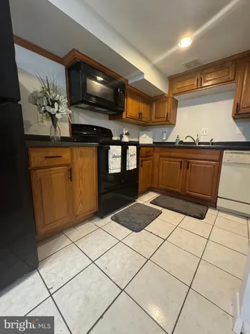 a kitchen with stainless steel appliances kitchen island granite countertop a sink and cabinets