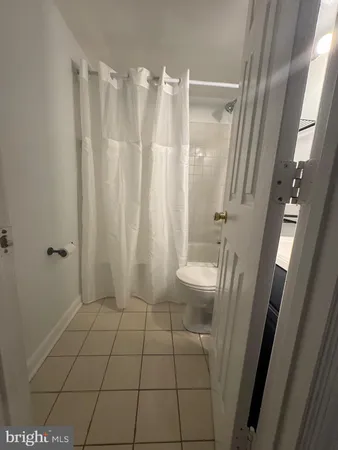 a bathroom with a shower and toilet