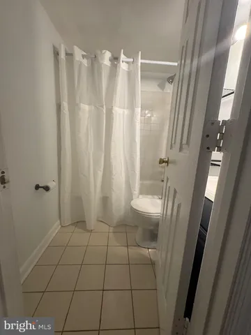 a bathroom with a shower and toilet