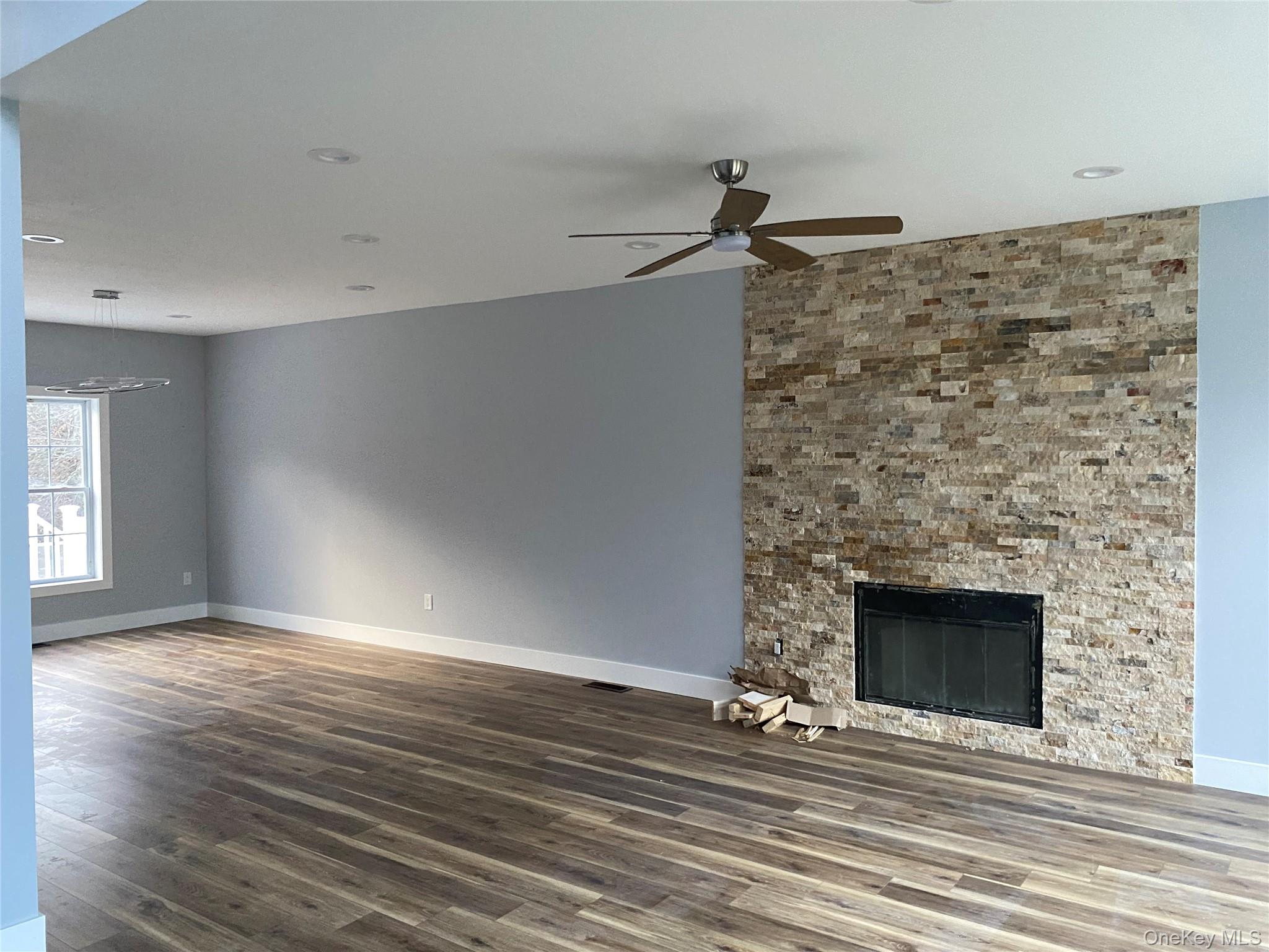 44 Roslyn Ridge Road Mongaup Valley, NY 12762 - Photo 6 of 24 Unfurnished living room featuring a large fireplace, dark wood finished floors, ceiling fan, and recessed lighting