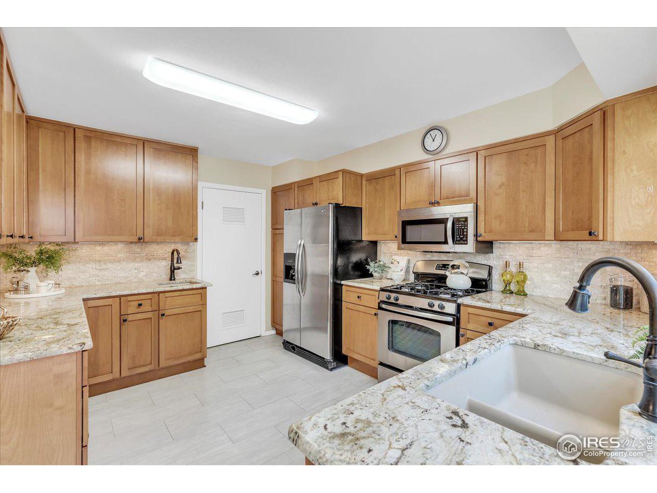 81 Benthaven Place Boulder, CO 80305 - Photo 11 of 32 a kitchen with stainless steel appliances granite countertop a sink refrigerator stove and microwave