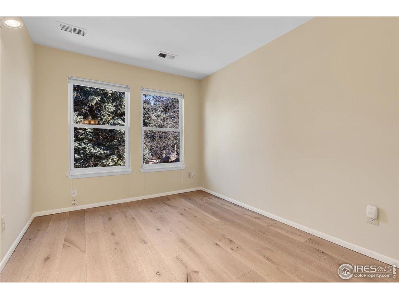 81 Benthaven Place Boulder, CO 80305 - Photo 14 of 32 an empty room with wooden floor and windows