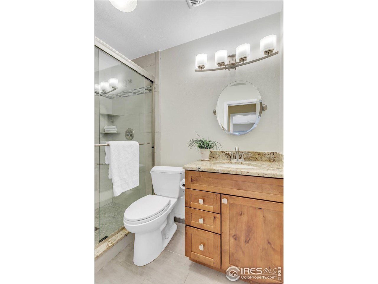 81 Benthaven Place Boulder, CO 80305 - Photo 17 of 32 a bathroom with a toilet a sink and a mirror