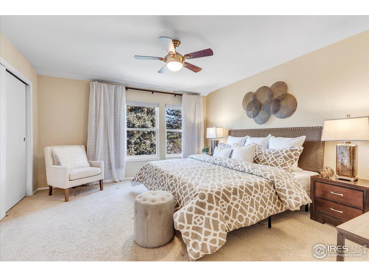 81 Benthaven Place Boulder, CO 80305 - Photo 20 of 32 a bedroom with a bed and a chandelier