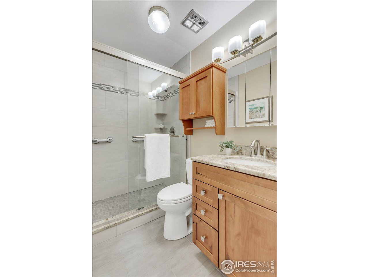 81 Benthaven Place Boulder, CO 80305 - Photo 23 of 32 a bathroom with a granite countertop toilet sink and mirror