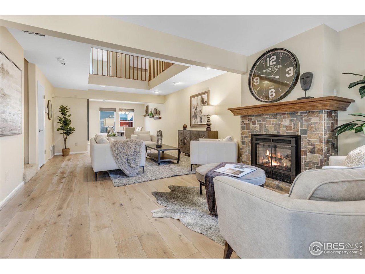 81 Benthaven Place Boulder, CO 80305 - Photo 32 of 32 a living room with furniture a clock and a fireplace