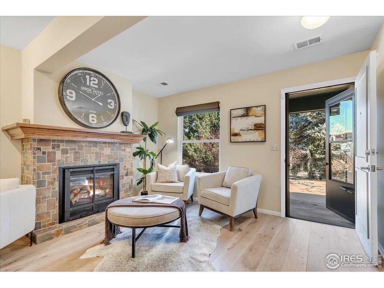 81 Benthaven Place Boulder, CO 80305 - Photo 5 of 32 a living room with furniture a clock and a fireplace