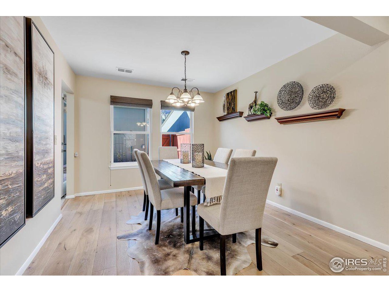81 Benthaven Place Boulder, CO 80305 - Photo 7 of 32 a dining room with furniture a chandelier and wooden floor
