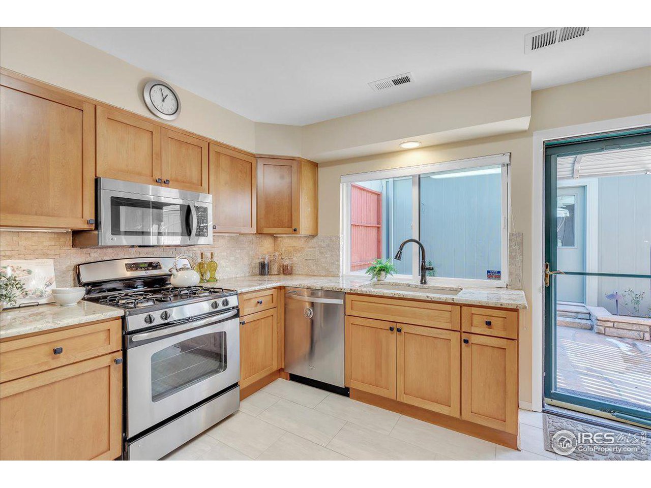 81 Benthaven Place Boulder, CO 80305 - Photo 9 of 32 a kitchen with granite countertop a sink stainless steel appliances and cabinets