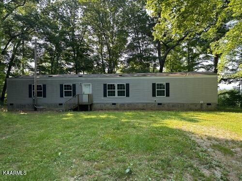 306 Dynatex Road Lancing, TN 37770 - Photo 1 of 13 front view of a house and a yard