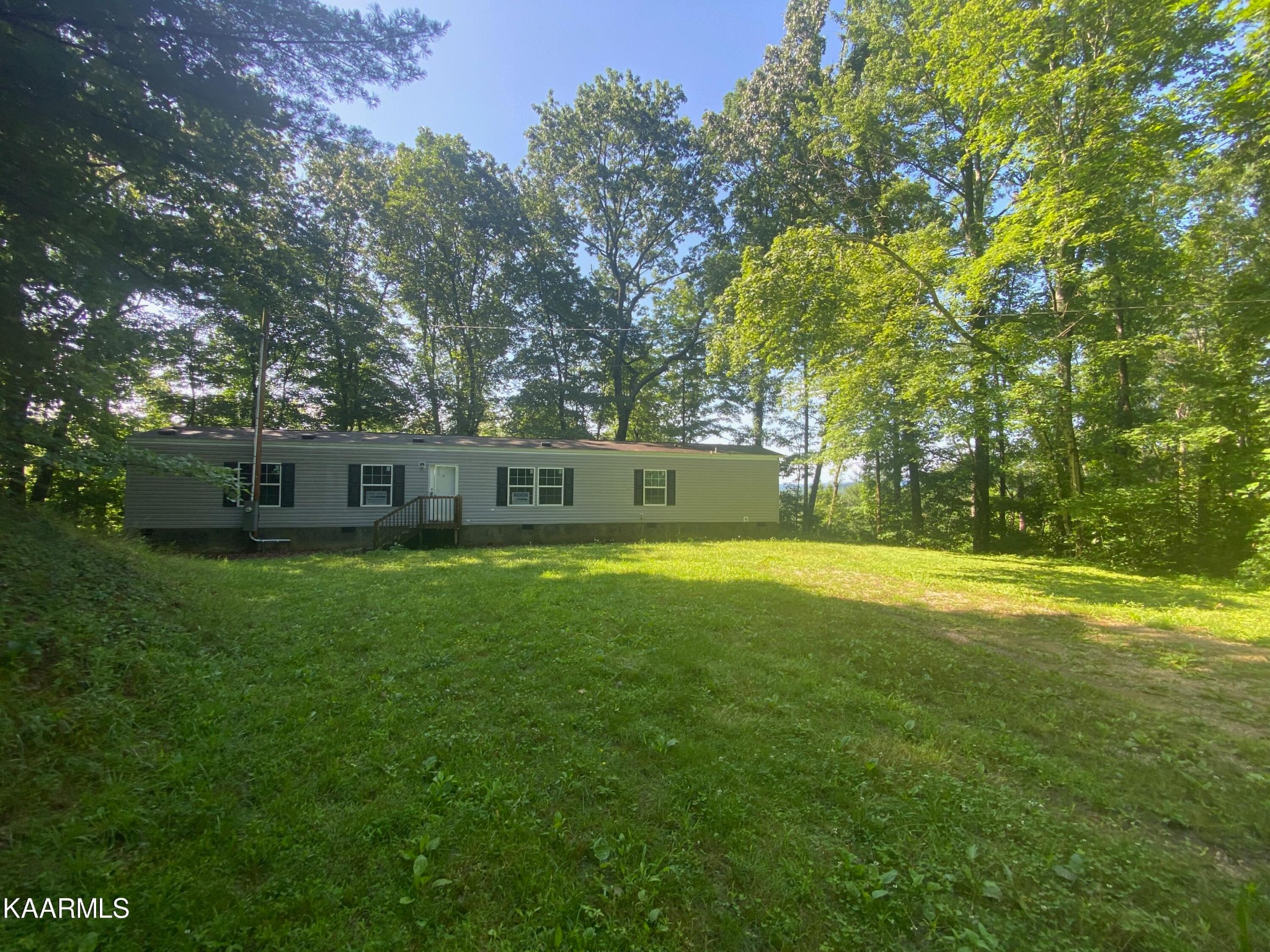 306 Dynatex Road Lancing, TN 37770 - Photo 11 of 13 a front view of a house with a garden