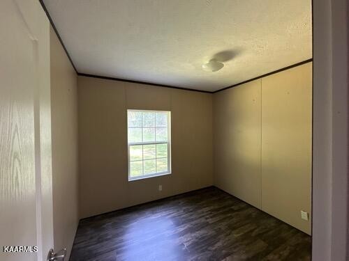 306 Dynatex Road Lancing, TN 37770 - Photo 4 of 13 an empty room with wooden floor and windows