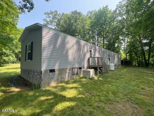 306 Dynatex Road Lancing, TN 37770 - Photo 10 of 13 a backyard of a house with table and chairs