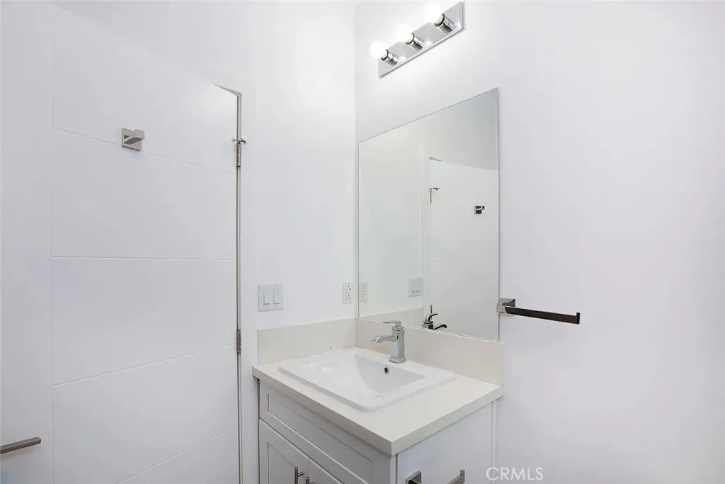 5024 Cleon Avenue North Hollywood, CA 91601 - Photo 19 of 22 a bathroom with a sink and a mirror