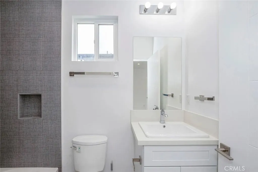 5024 Cleon Avenue North Hollywood, CA 91601 - Photo 21 of 22 a bathroom with a sink a toilet and a mirror