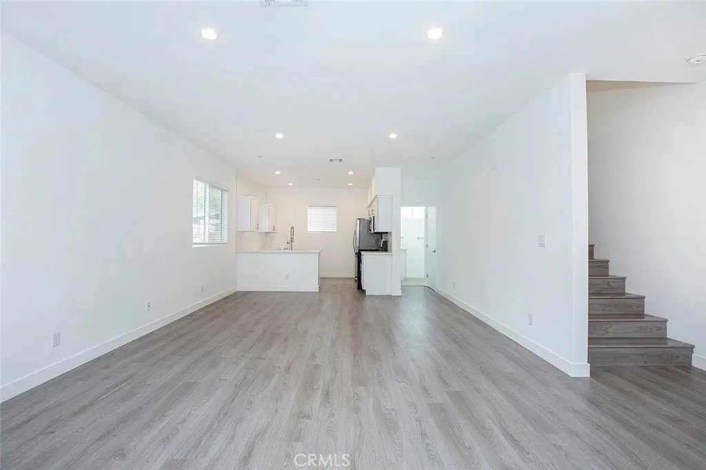 5024 Cleon Avenue North Hollywood, CA 91601 - Photo 3 of 22 a view of an empty room with wooden floor and a window