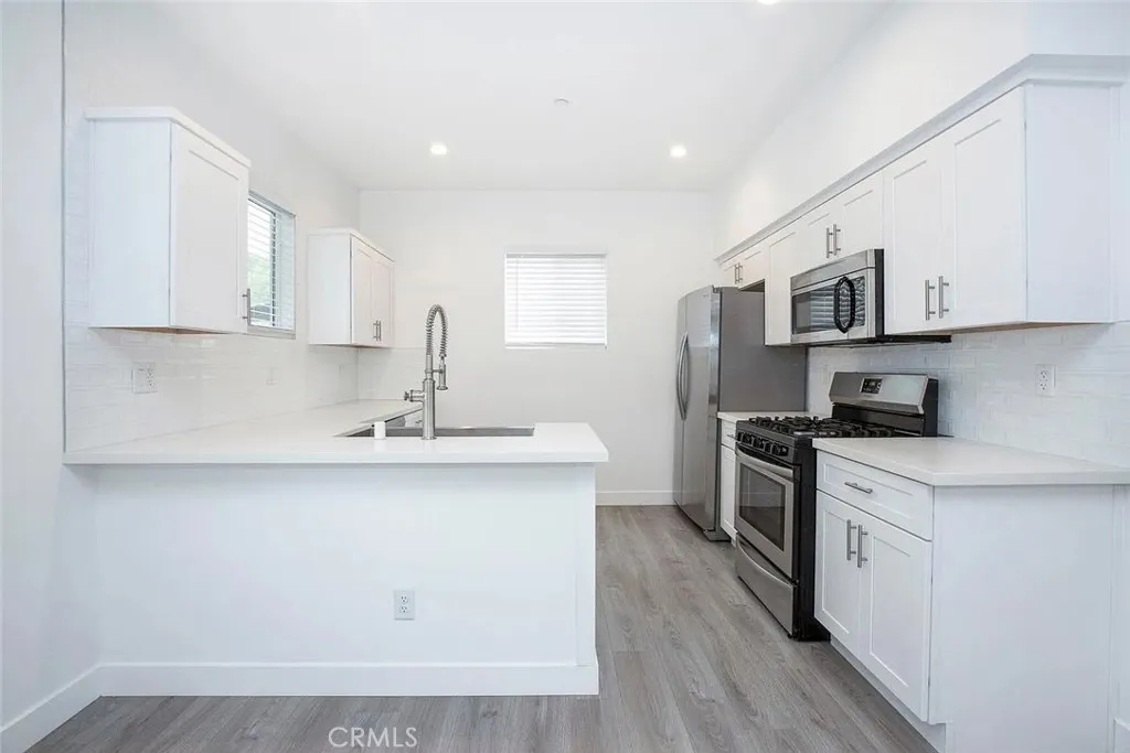 5024 Cleon Avenue North Hollywood, CA 91601 - Photo 4 of 22 a kitchen with stainless steel appliances granite countertop a sink stove and microwave