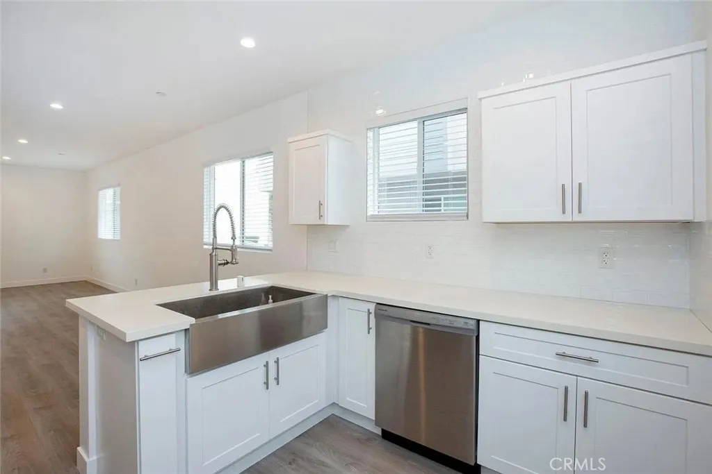 5024 Cleon Avenue North Hollywood, CA 91601 - Photo 8 of 22 a kitchen with white cabinets appliances a sink and a window
