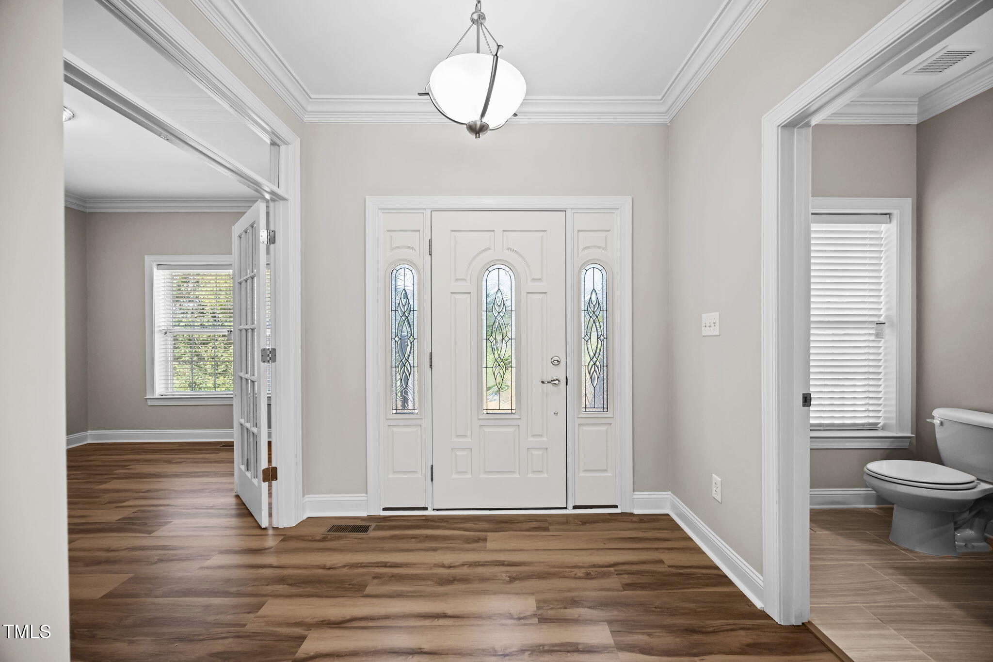 6117 David Moore Road Burlington, NC 27217 - Photo 8 of 51 an empty room with wooden floor mirror and windows