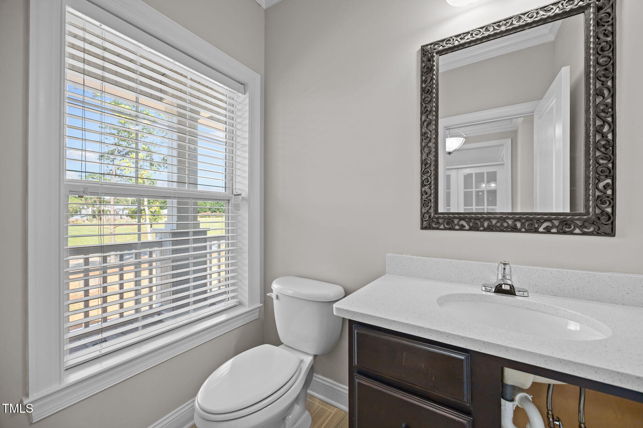 6117 David Moore Road Burlington, NC 27217 - Photo 9 of 51 a bathroom with a granite countertop toilet a sink a mirror and a window