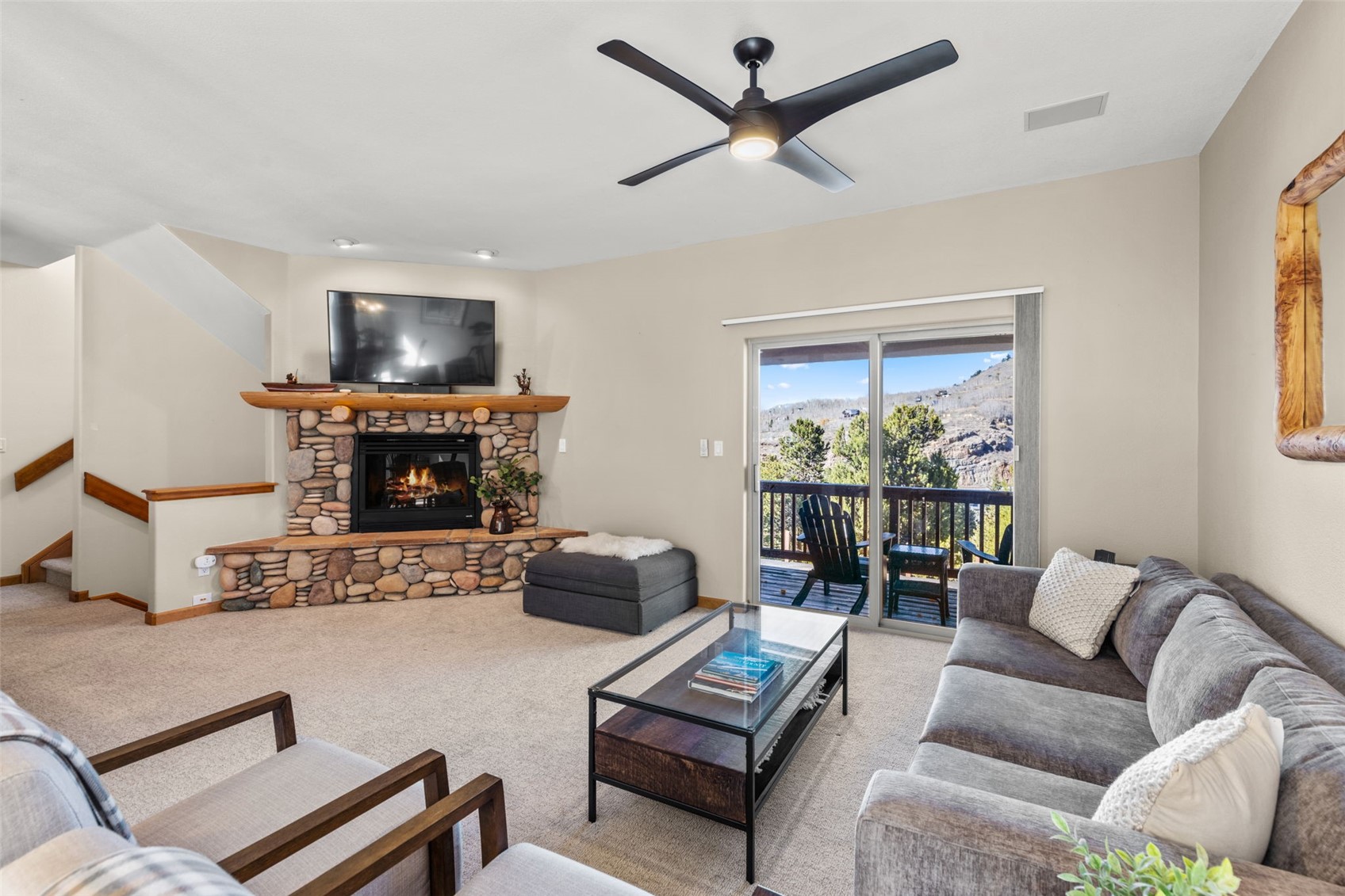 142 Lookout Ridge Drive Dillon, CO 80435 - Photo 3 of 39 Living room featuring a fireplace, ceiling fan and deck