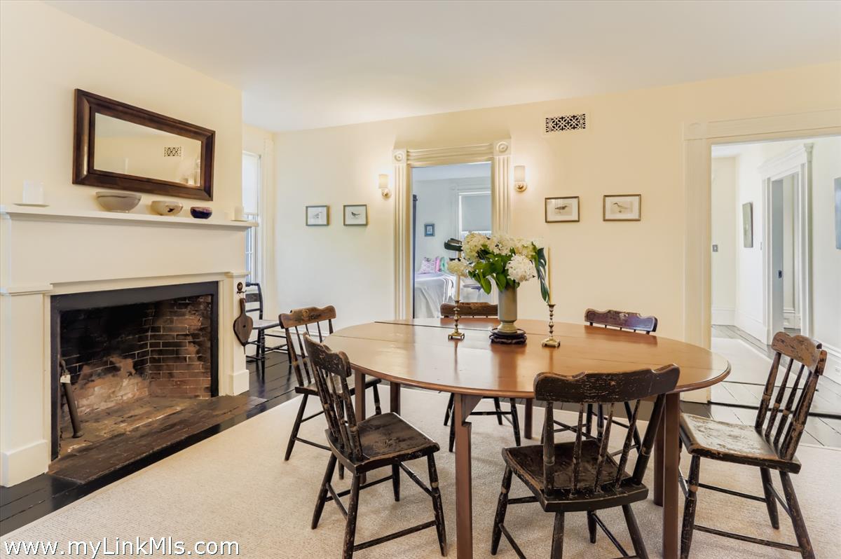27 Spring Street Vineyard Haven, MA 02568 - Photo 32 of 58 a view of a dining room with furniture and a fireplace