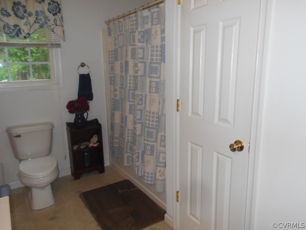 1925 Hill Cross Road Charlotte Court House, VA 23923 - Photo 20 of 50 a bathroom with a toilet and a shower curtain