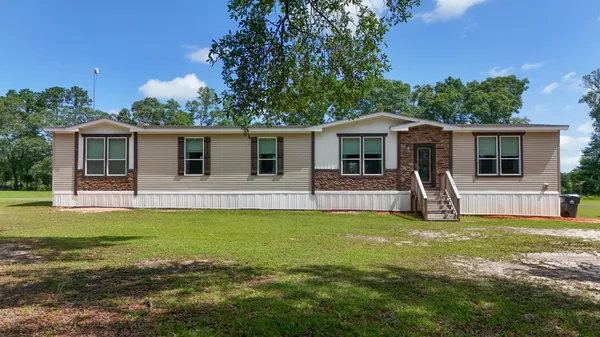 a front view of house with yard livingroom and outdoor seating