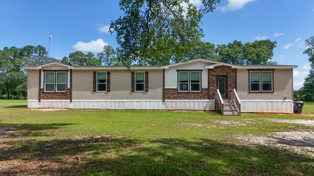 a front view of house with yard livingroom and outdoor seating
