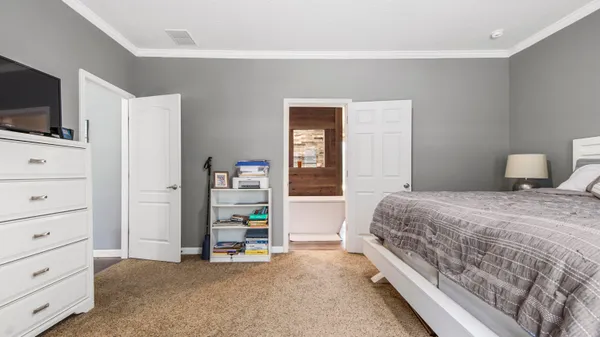 a bedroom with a bed and flat screen tv